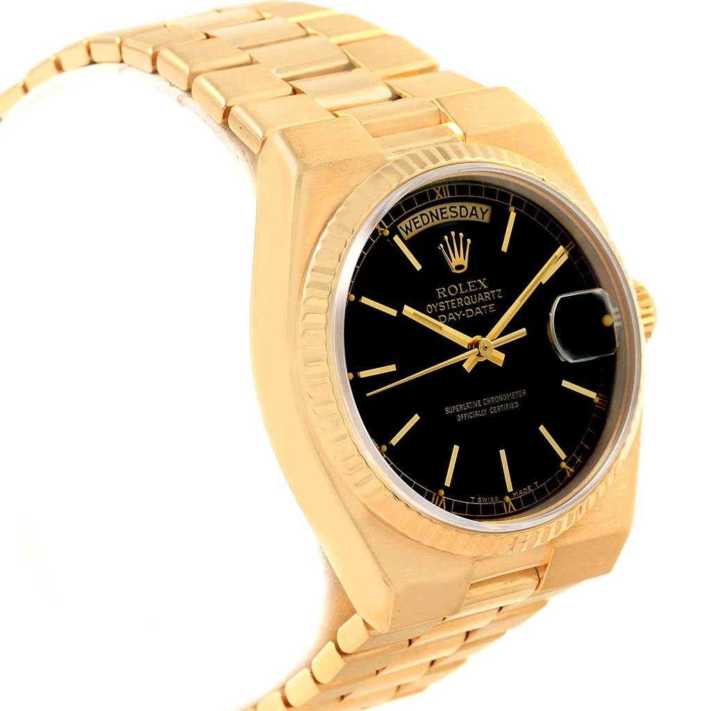 This Rolex Oysterquartz 19018 Men
s Yellow Gold Black Dial 19018 Men
s Yellow Gold Black Dial watch is shown from a three-quarter view, displaying its gold bracelet, black dial, and fluted bezel.