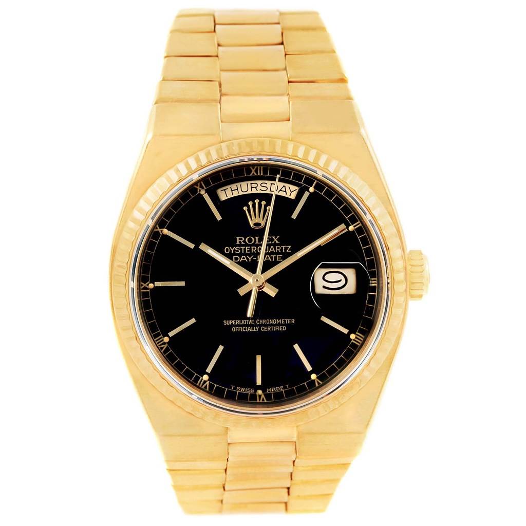The image shows a front view of a Rolex Oysterquartz 19018 Men's Yellow Gold Black Dial 19018 Men's Yellow Gold Black Dial Day-Date watch, featuring a gold bracelet and black dial.