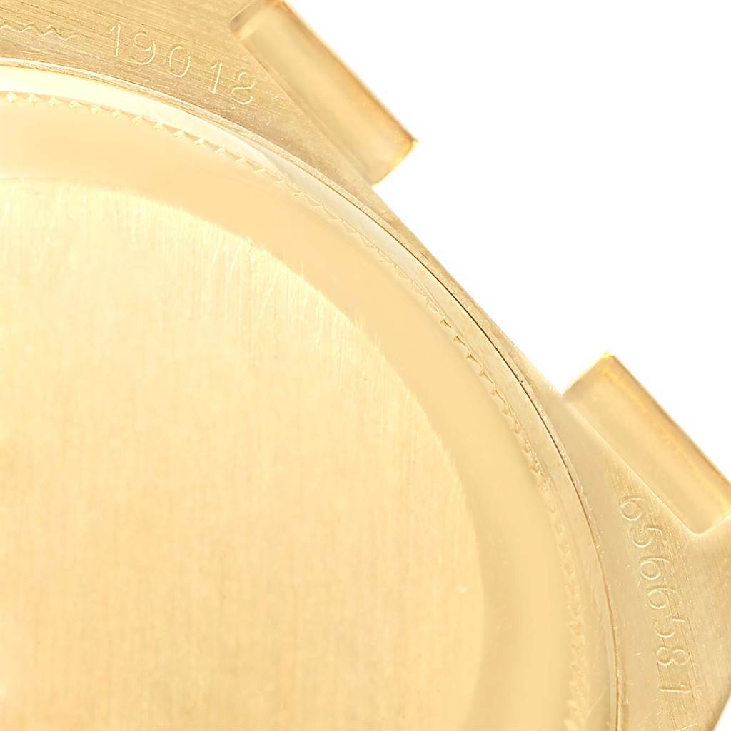 This is a close-up of the case back and lugs of a Rolex Oysterquartz 19018 Men's Yellow Gold Black Dial 19018 Men's Yellow Gold Black Dial model 19018, showing some of its engraved serial numbers.