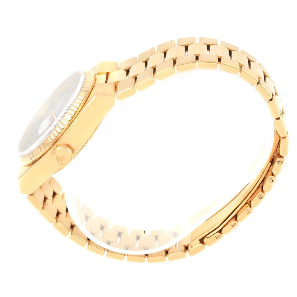 The image shows the side view of a Rolex Oysterquartz 19018 Men's Yellow Gold Black Dial 19018 Men's Yellow Gold Black Dial watch, highlighting its crown, case, and the bracelet.