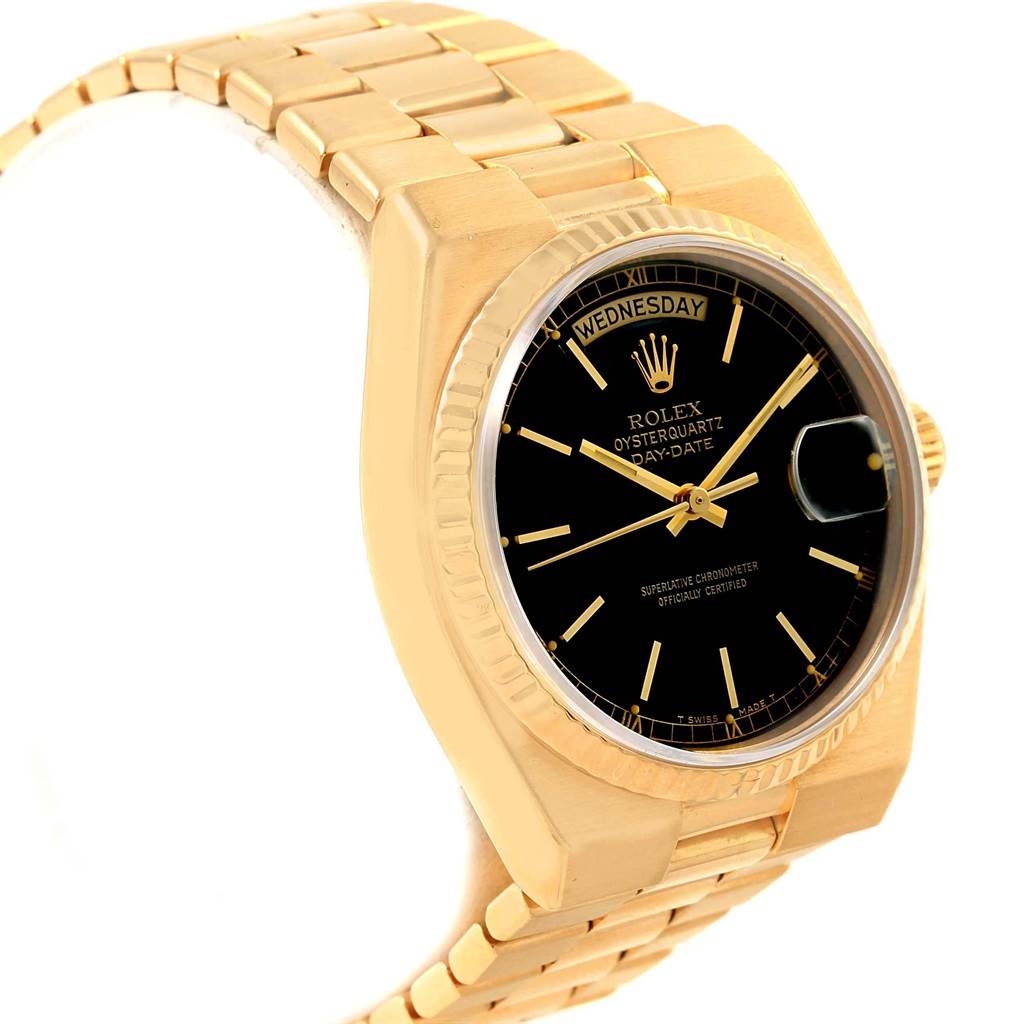 The Rolex Oysterquartz 19018 Men's Yellow Gold Black Dial 19018 Men's Yellow Gold Black Dial watch is shown from a slightly tilted side angle, displaying the face, case, bezel, crown, and bracelet parts.
