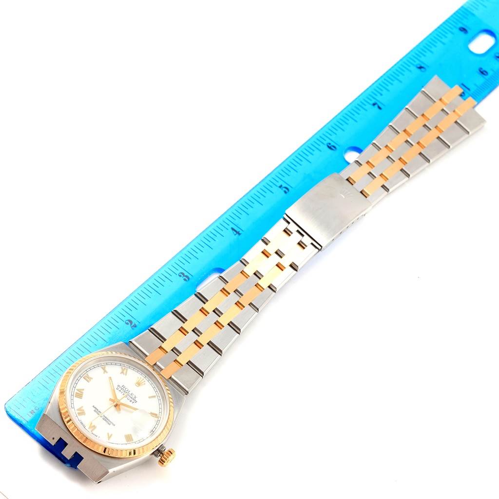 The image shows a Rolex Oysterquartz 17013 Men's Stainless Steel White Dial 17013 Men's Stainless Steel White Dial watch laid flat with its dial, bracelet, and buckle visible, alongside a blue ruler for size reference.