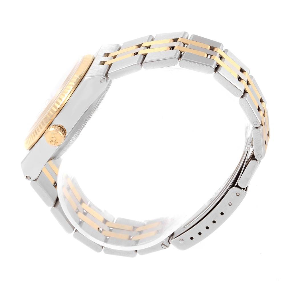 The image shows the side view of a Rolex Oysterquartz 17013 Men's Steel and Gold (two tone) White Dial 17013 Men's Steel and Gold (two tone) White Dial watch, highlighting the gold bezel, crown, and two-tone metal bracelet.