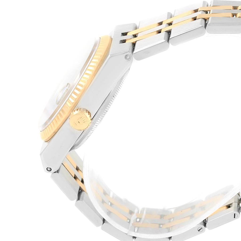 The Rolex Oysterquartz 17013 Men's Stainless Steel Blue Dial 17013 Men's Stainless Steel Blue Dial watch is shown from a side angle, highlighting the crown, case, and two-tone bracelet.