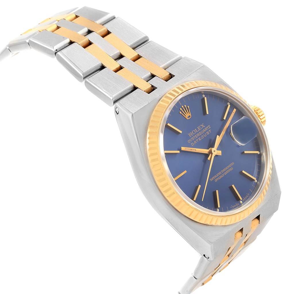 The image shows a side angle of the Rolex Oysterquartz 17013 Men's Stainless Steel Blue Dial 17013 Men's Stainless Steel Blue Dial watch, highlighting the bracelet, case, and blue dial with a gold bezel and markers.