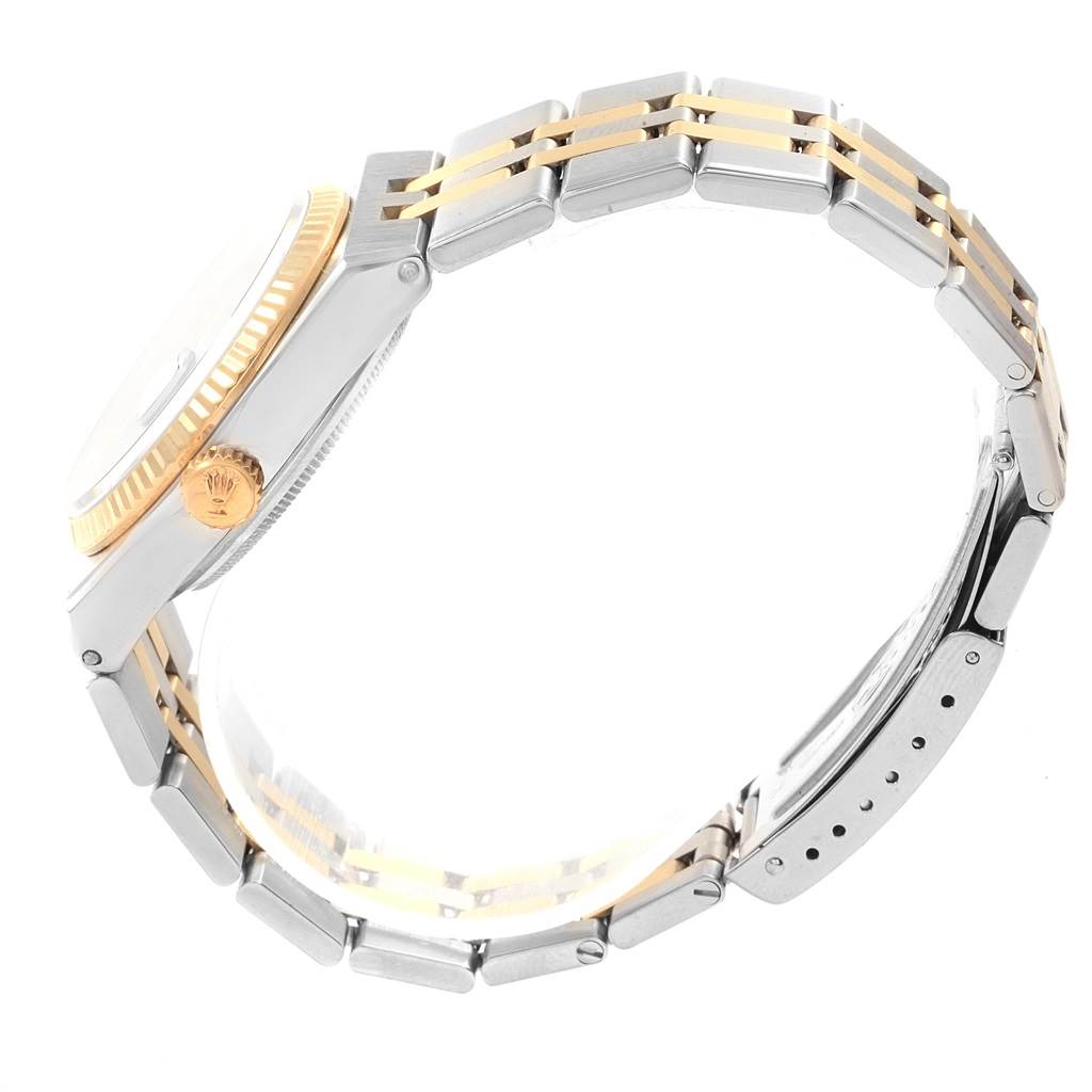 The Rolex Oysterquartz 17013 Men's Stainless Steel Blue Dial 17013 Men's Stainless Steel Blue Dial watch is shown from a side angle, displaying the crown, bezel, and bracelet with gold accents.