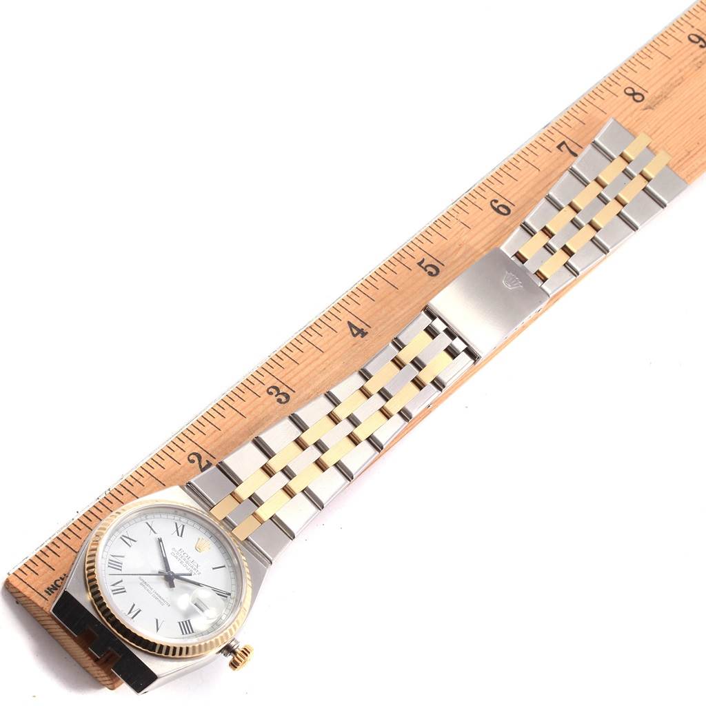The image shows a Rolex Oysterquartz 17013 Men's Steel and Gold (two tone) White Dial 17013 Men's Steel and Gold (two tone) White Dial watch laid flat with a wooden ruler for scale, displaying the entire face and two-tone bracelet.