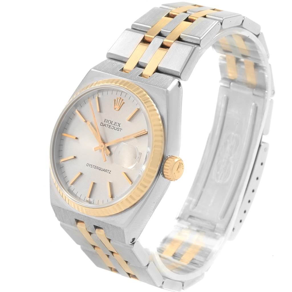 The Rolex Oysterquartz 17013 Men's Stainless Steel Silver Dial 17013 Men's Stainless Steel Silver Dial Datejust watch is shown at an angle displaying the face, bezel, crown, and part of the two-tone bracelet.