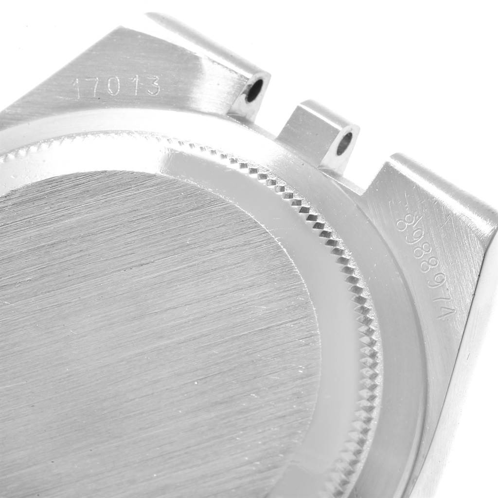 The image shows a close-up of the back case and lugs of a Rolex Oysterquartz 17013 Men's Stainless Steel Champagne Dial 17013 Men's Stainless Steel Champagne Dial watch, displaying model and serial numbers.
