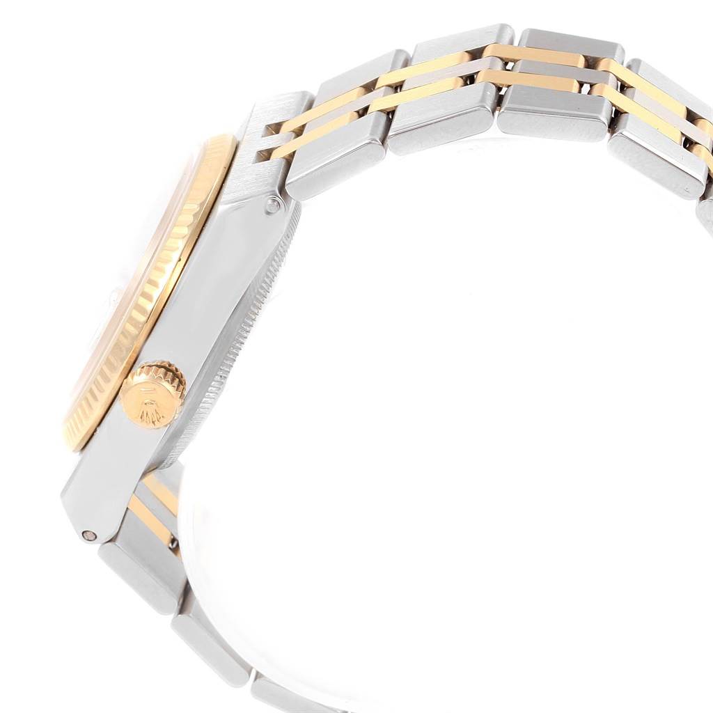 The image shows a side view of the Rolex Oysterquartz 17013 Men's Steel and Gold (two tone) White Dial 17013 Men's Steel and Gold (two tone) White Dial watch, highlighting the crown, bezel, and two-tone bracelet.