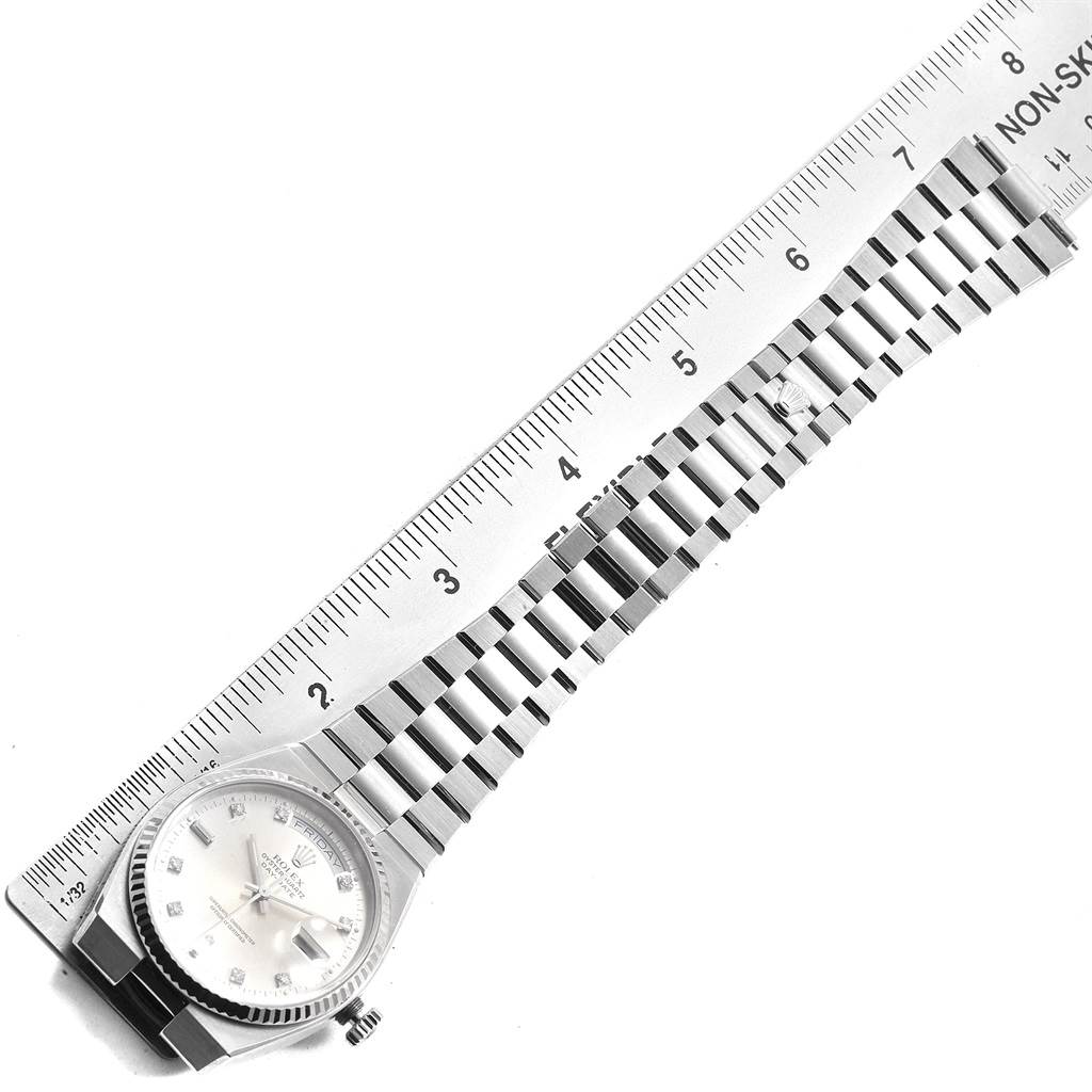 The image shows the Rolex Oysterquartz 19019 Men's White Gold Silver Dial 19019 Men's White Gold Silver Dial watch face, bracelet, and a ruler measuring the bracelet's length.