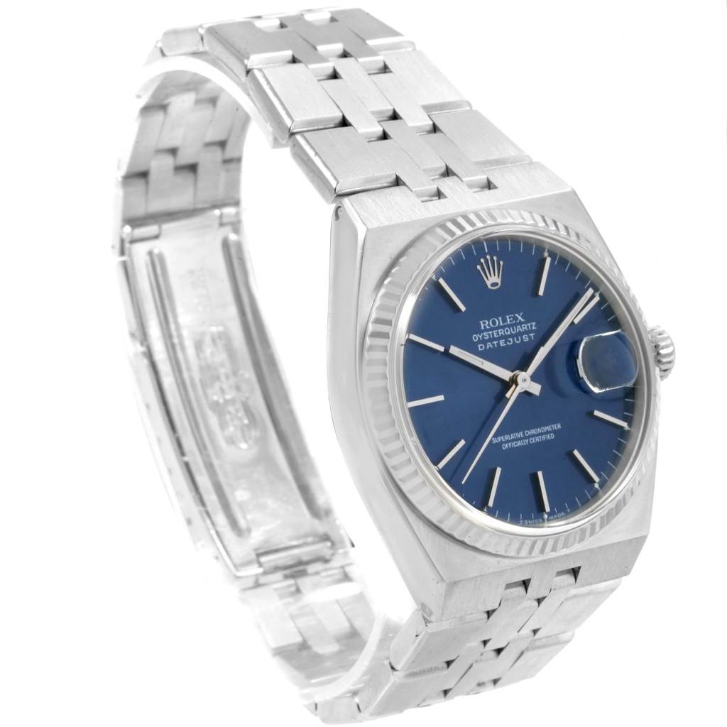 The image shows an angled view of a Rolex Oysterquartz 17014 Men's Stainless Steel Blue Dial 17014 Men's Stainless Steel Blue Dial Datejust watch with a blue dial and metal bracelet.