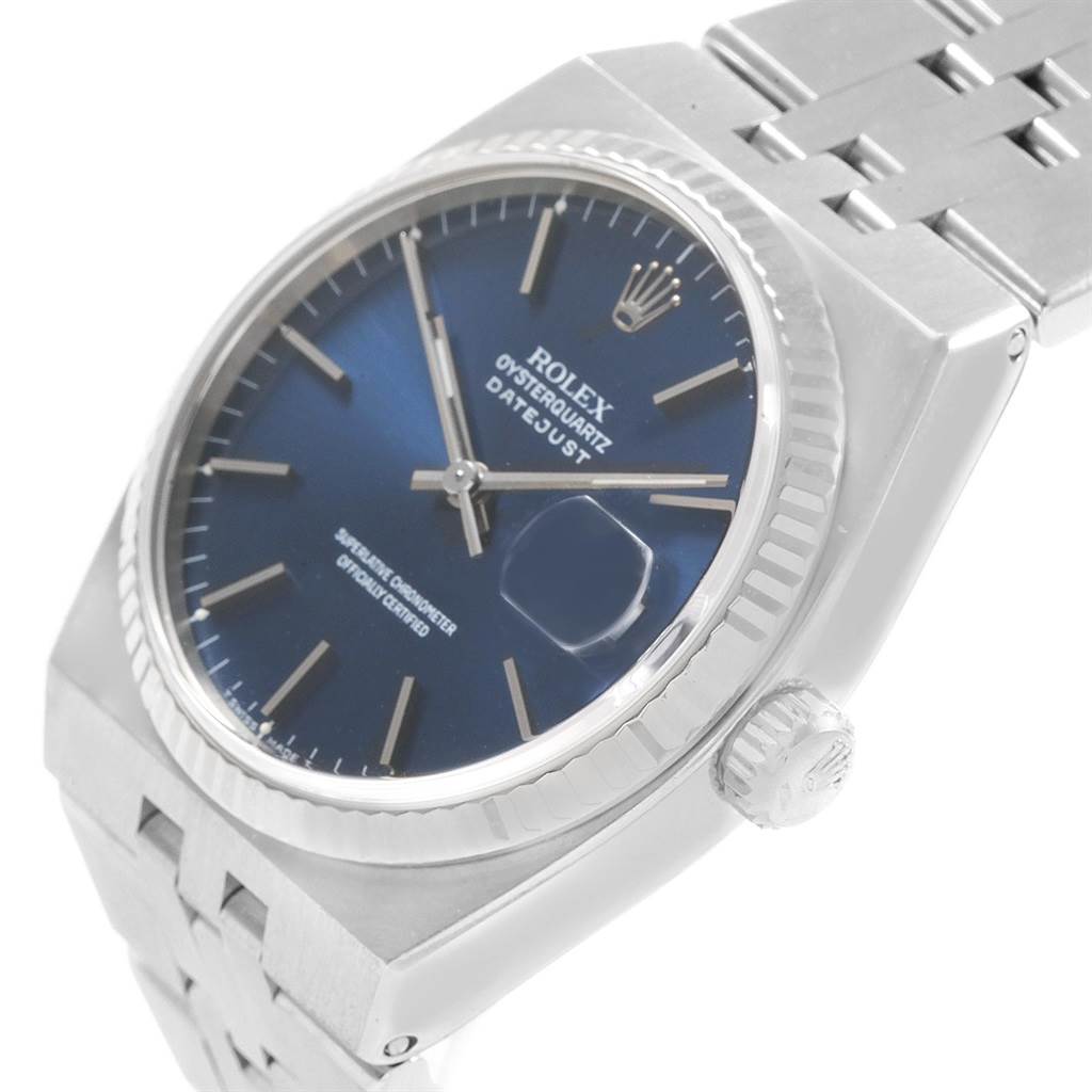 The Rolex Oysterquartz 17014 Men's Stainless Steel Blue Dial 17014 Men's Stainless Steel Blue Dial watch is shown from an angled perspective, displaying its face, crown, bezel, and part of the bracelet.