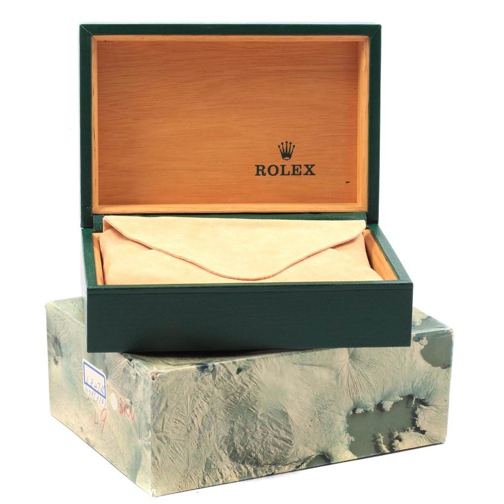 The image shows an open green Rolex box with a beige cushion, meant for the Oysterquartz model by Rolex.