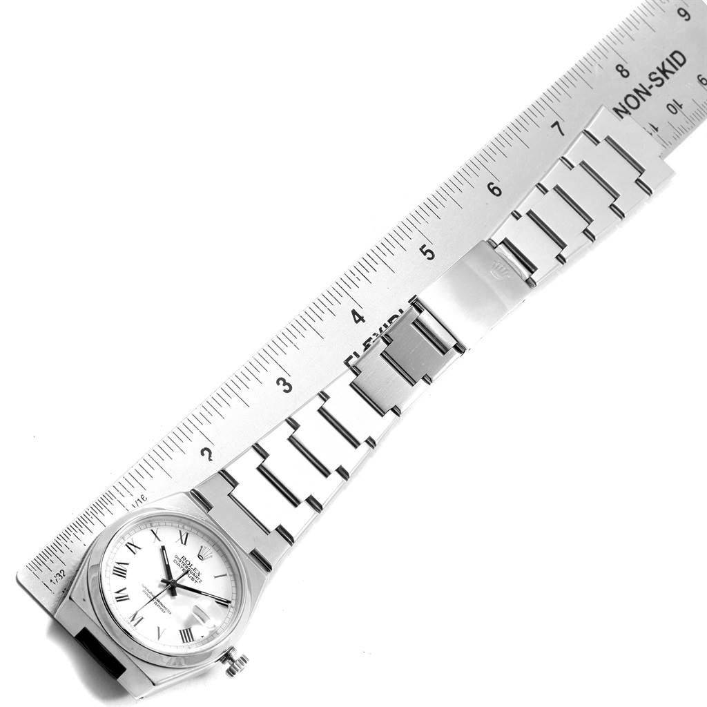 This image shows the full length of a Rolex Oysterquartz 17000 Men's Stainless Steel White Dial 17000 Men's Stainless Steel White Dial watch, including the face and metal bracelet, with a ruler for scale.