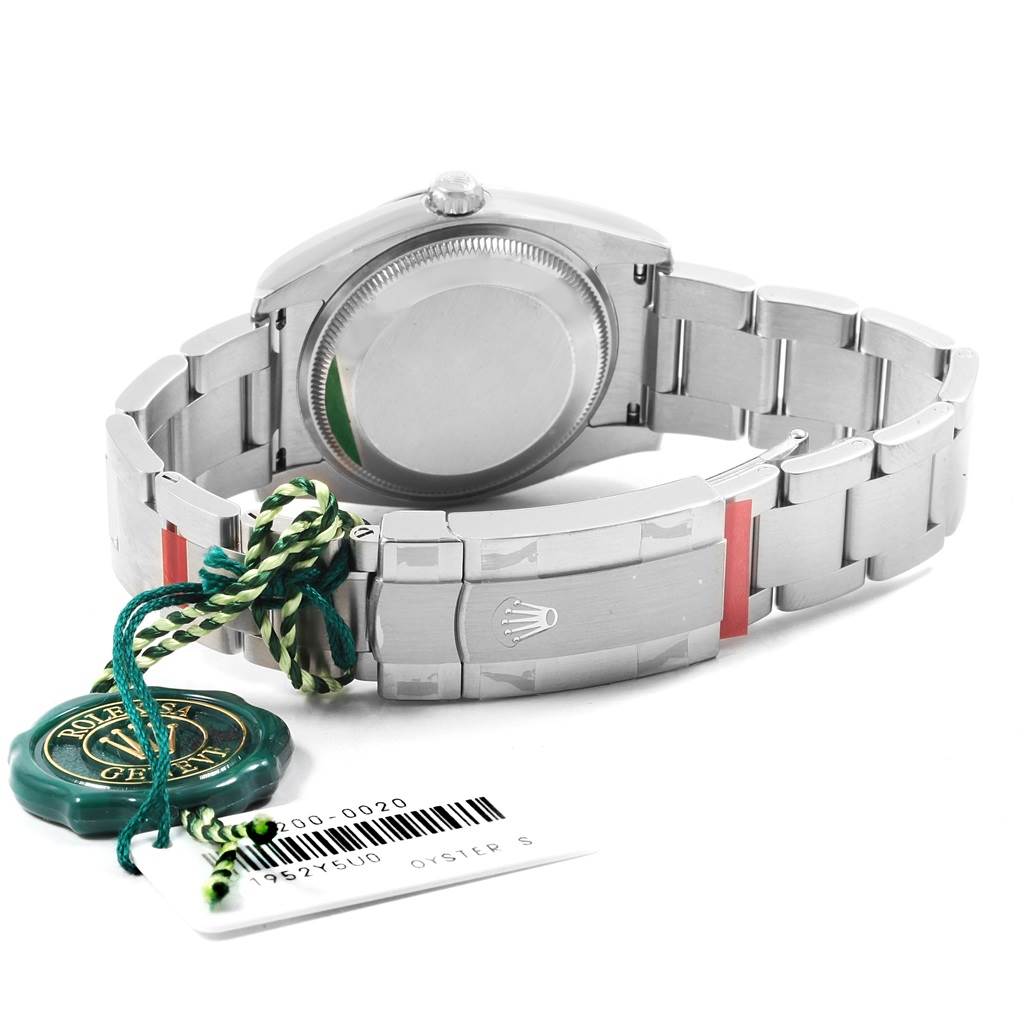 The image shows the back and the clasp of the Rolex Oysterquartz 114200 Men
s Stainless Steel Burgundy Dial 114200 Men
s Stainless Steel Burgundy Dial watch, along with attached tags.