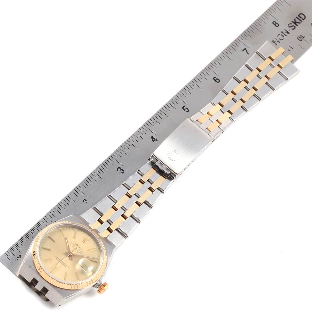 The image shows a Rolex Oysterquartz 17013 Men
s Stainless Steel Champagne Dial 17013 Men
s Stainless Steel Champagne Dial watch, laid flat and measured with a ruler, highlighting the face, crown, bracelet, and deployment clasp.