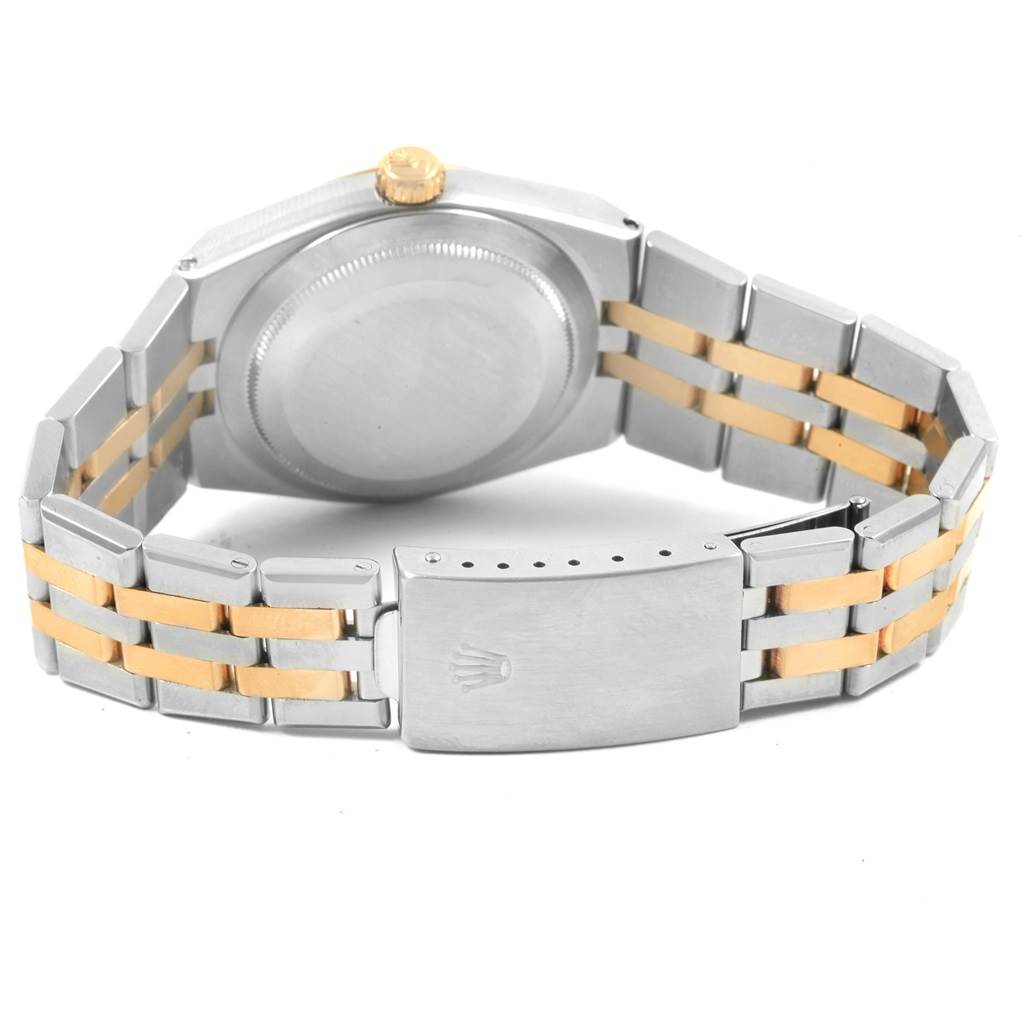 The image shows the back view of a Rolex Oysterquartz 17013 Men
s Stainless Steel Champagne Dial 17013 Men
s Stainless Steel Champagne Dial watch, focusing on its case back, crown, and two-tone bracelet with a clasp.