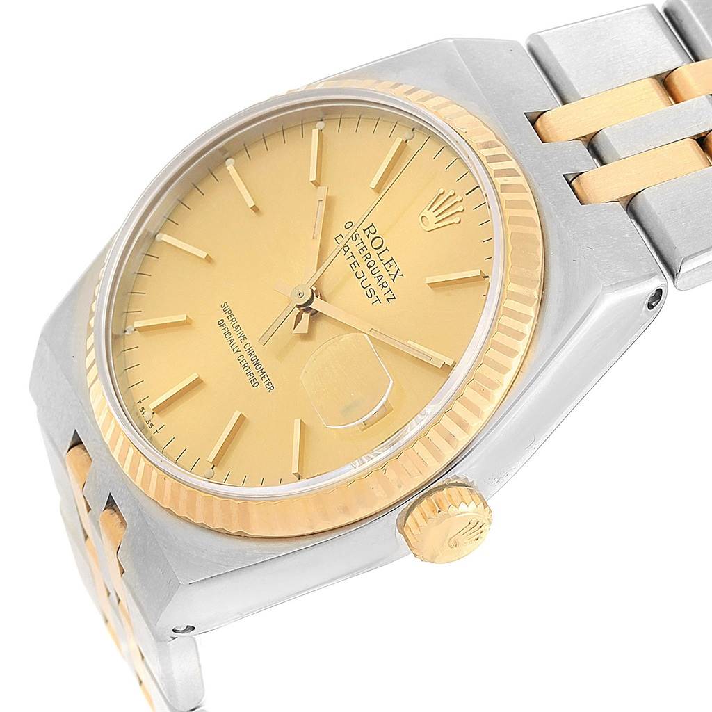 The image shows a Rolex Oysterquartz 17013 Men
s Stainless Steel Champagne Dial 17013 Men
s Stainless Steel Champagne Dial watch from a slightly angled top view, displaying its gold dial, fluted bezel, and two-tone bracelet.
