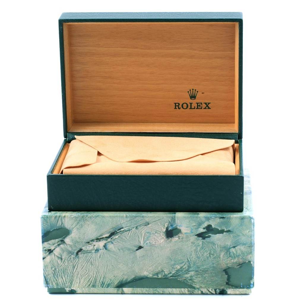 This image shows an open Rolex box lined with wood and containing a cushioned cover, likely for an Oysterquartz model watch.