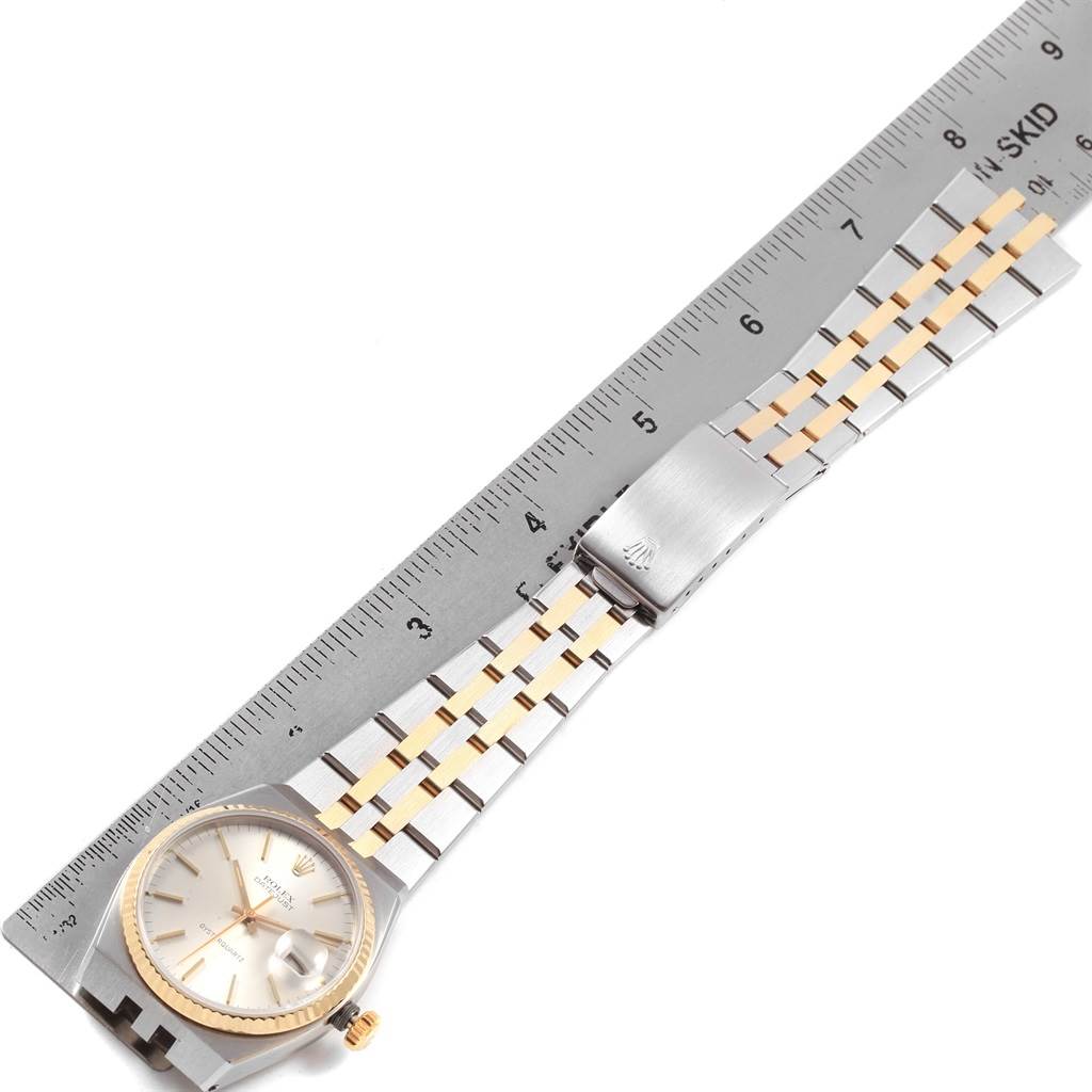 The image shows a Rolex Oysterquartz 17013 Men
s Stainless Steel Silver Dial 17013 Men
s Stainless Steel Silver Dial watch with a two-tone bracelet, measured alongside a ruler for scale.