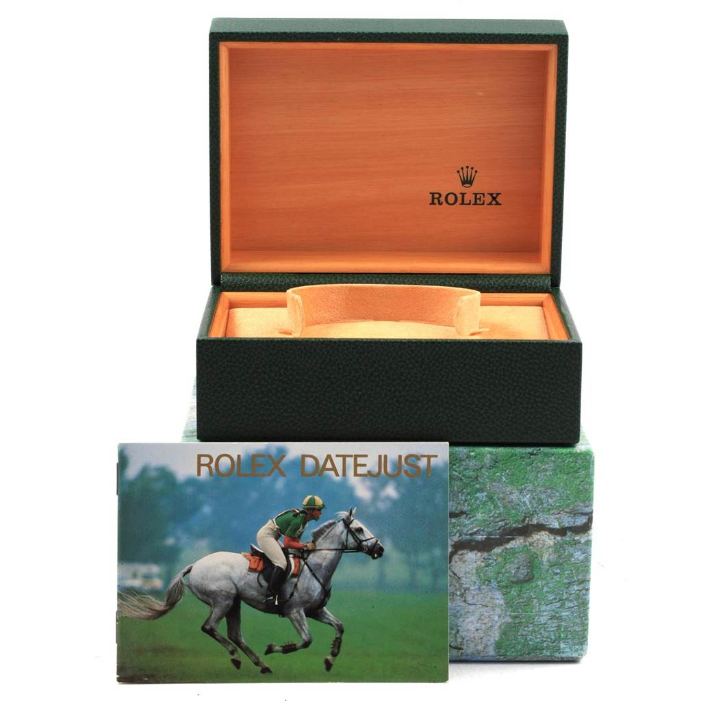 The image shows an open Rolex Oysterquartz 21993 Men
s Stainless Steel Silver Dial 21993 Men
s Stainless Steel Silver Dial watch box with a green outer cover and a Rolex Datejust booklet with a horse rider image.