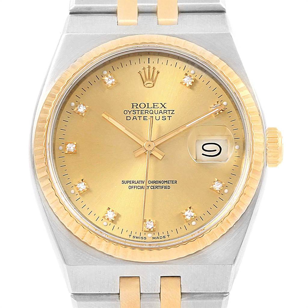 This image shows a frontal view of the Rolex Oysterquartz 17013 Men's Stainless Steel Champagne Dial 17013 Men's Stainless Steel Champagne Dial Datejust watch, highlighting its gold dial, date window, and diamond hour markers.