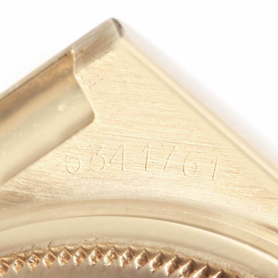 This image shows a close-up of the case corner and part of the bezel of a Rolex Oysterquartz 19018 Men's Yellow Gold White Dial 19018 Men's Yellow Gold White Dial watch, displaying its serial number.