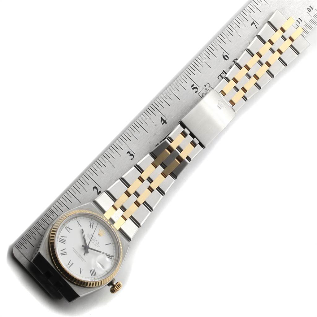 The image shows a Rolex Oysterquartz 17013 Men's Steel and Gold (two tone) White Dial 17013 Men's Steel and Gold (two tone) White Dial watch laid flat next to a ruler, displaying the face, bracelet, and clasp.