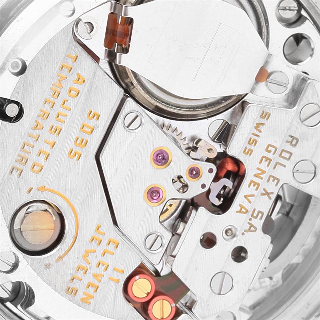 Close-up view of the internal mechanism of a Rolex Oysterquartz 17013 Men's Steel and Gold (two tone) White Dial 17013 Men's Steel and Gold (two tone) White Dial watch, showing the gears, jewels, and inscriptions.