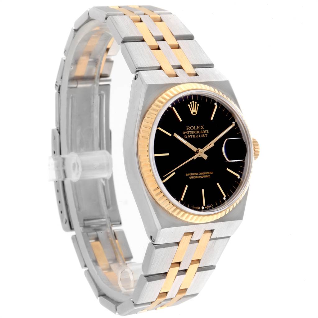 The Rolex Oysterquartz 17013 Men
s Stainless Steel Black Dial 17013 Men
s Stainless Steel Black Dial watch is shown at an angle highlighting its black dial, gold bezel, and two-tone bracelet.
