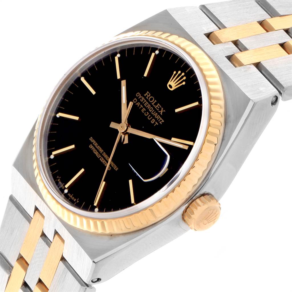 The image shows a Rolex Oysterquartz 17013 Men
s Stainless Steel Black Dial 17013 Men
s Stainless Steel Black Dial watch at an angled view, highlighting the black dial, gold bezel, crown, and two-tone bracelet.