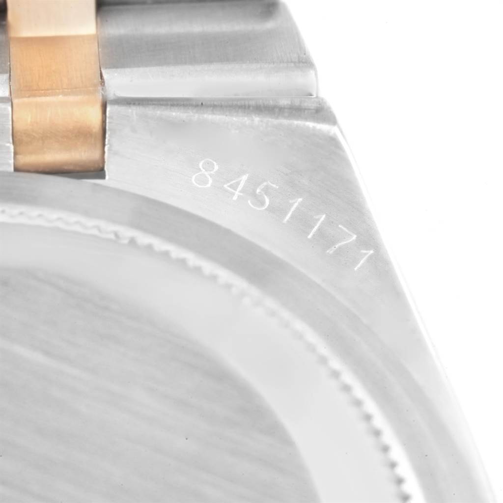 The image shows a close-up of the Rolex Oysterquartz 17013 Men
s Stainless Steel Black Dial 17013 Men
s Stainless Steel Black Dial watch, focusing on the serial number and part of the metal bracelet attachment.