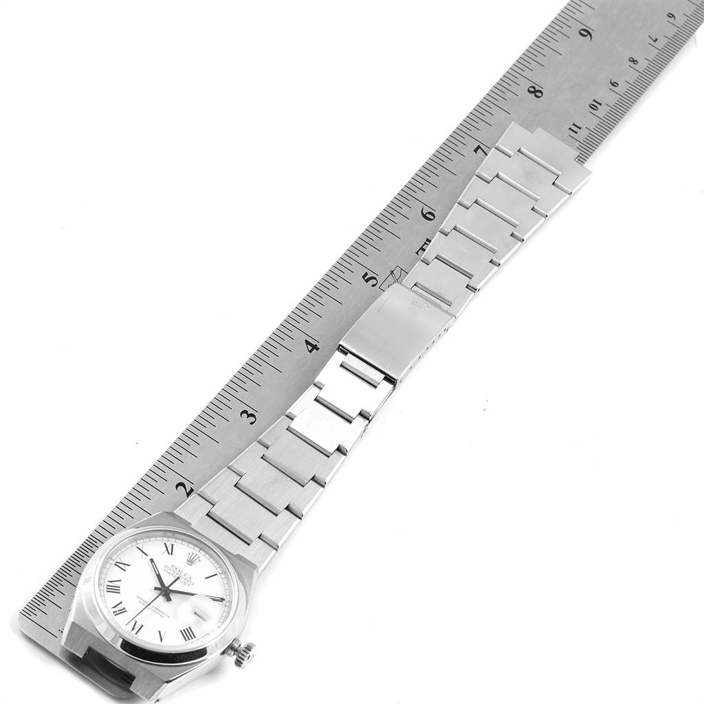 The image shows a Rolex Oysterquartz 17000 Men's Stainless Steel White Dial 17000 Men's Stainless Steel White Dial watch laying flat next to a ruler, displaying the watch face and band.
