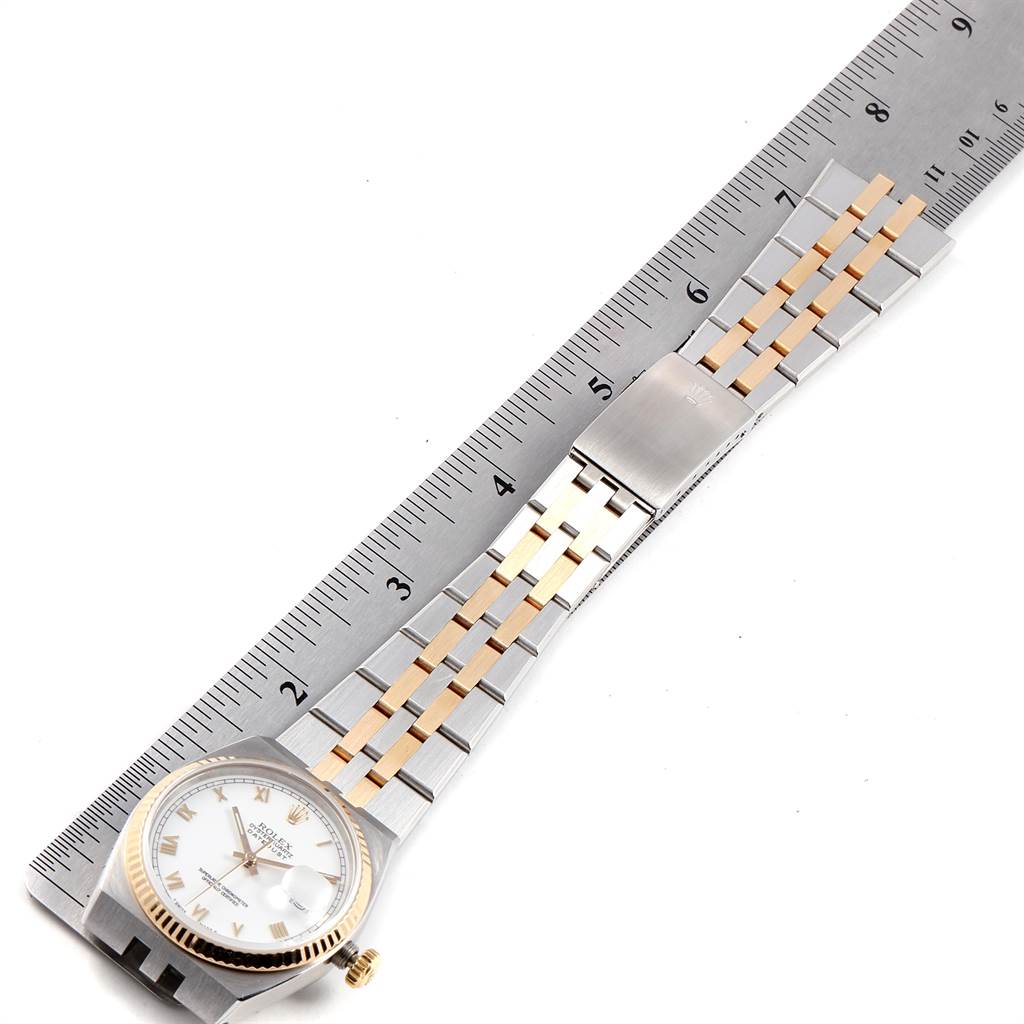 The image shows a top-down view of a Rolex Oysterquartz 17013 Men's Stainless Steel White Dial 17013 Men's Stainless Steel White Dial watch, including the face, bezel, and bracelet next to a ruler.