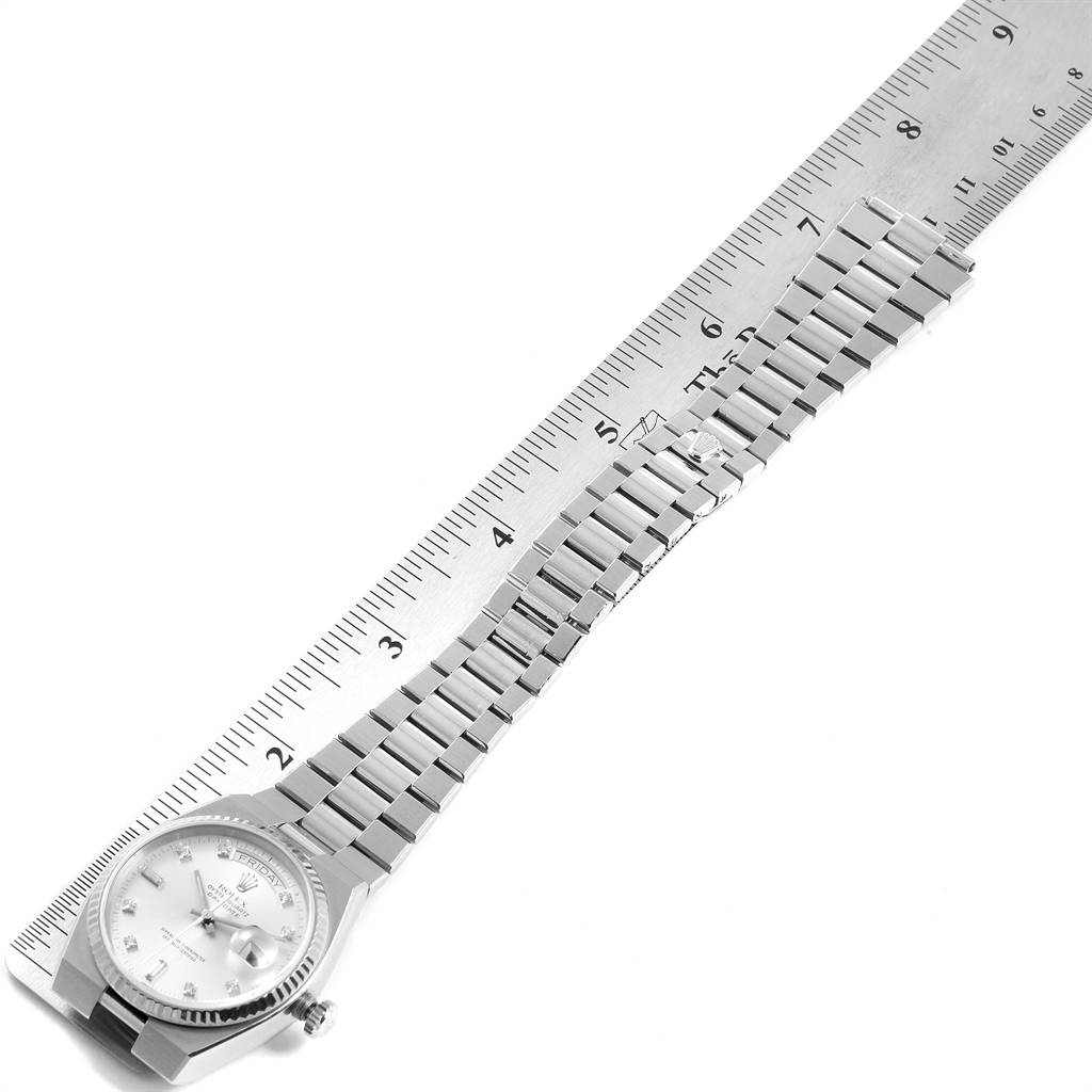 The image shows an angled top view of the Rolex Oysterquartz 19019 Men
s White Gold Silver Dial 19019 Men
s White Gold Silver Dial watch, including its face, bracelet, and part of a ruler.