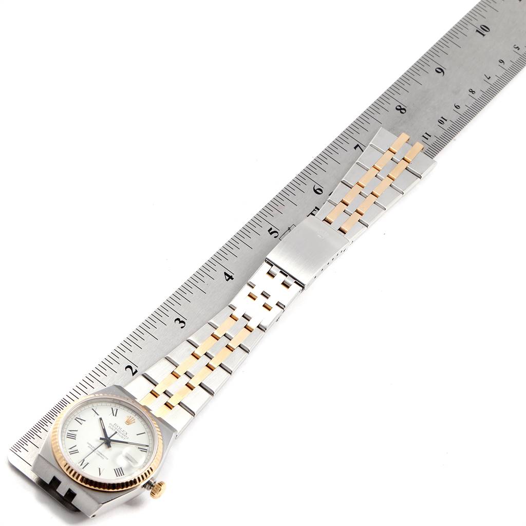 The image shows a Rolex Oysterquartz 19220 Men's Steel and Gold (two tone) White Dial 19220 Men's Steel and Gold (two tone) White Dial watch from a top-down angle with its full band extended next to a ruler for measurement.