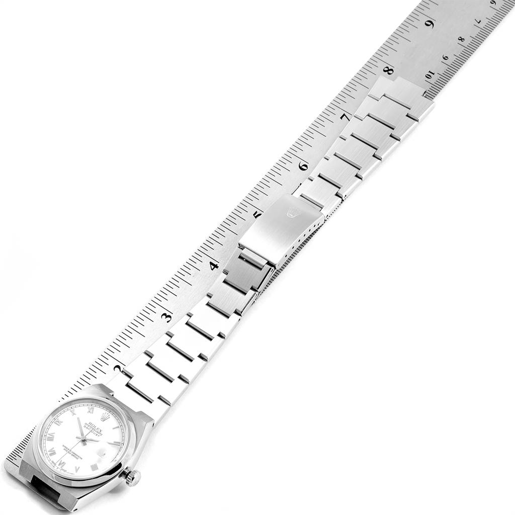 The Rolex Oysterquartz 17000 Men's Stainless Steel White Dial 17000 Men's Stainless Steel White Dial watch is shown from a top-down angle, displaying the entire band, clasp, and face alongside a ruler for scale.