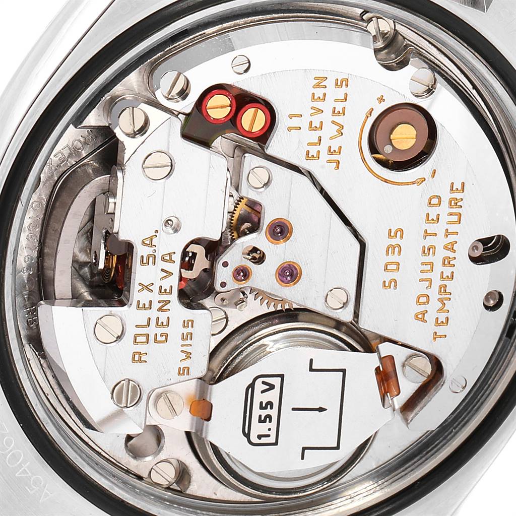This close-up image shows the internal mechanism of a Rolex Oysterquartz 17000 Men's Stainless Steel White Dial 17000 Men's Stainless Steel White Dial watch, highlighting the gear and battery components.