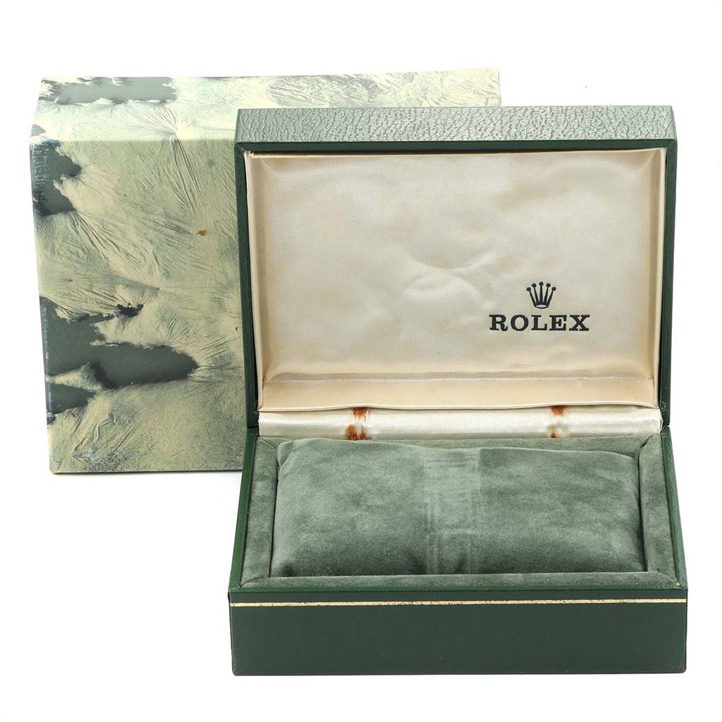 This image shows the open packaging of a Rolex Oysterquartz 19601 Men's Stainless Steel White Dial 19601 Men's Stainless Steel White Dial watch, featuring a green box with a logo.