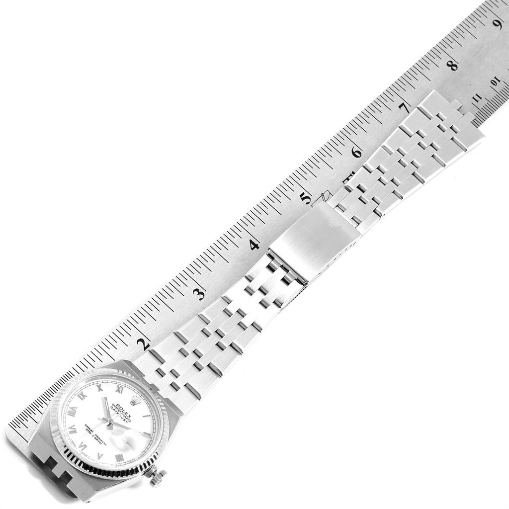 The image shows a top view of a Rolex Oysterquartz 19601 Men's Stainless Steel White Dial 19601 Men's Stainless Steel White Dial watch, highlighting its bracelet and clasp, with a ruler for scale.