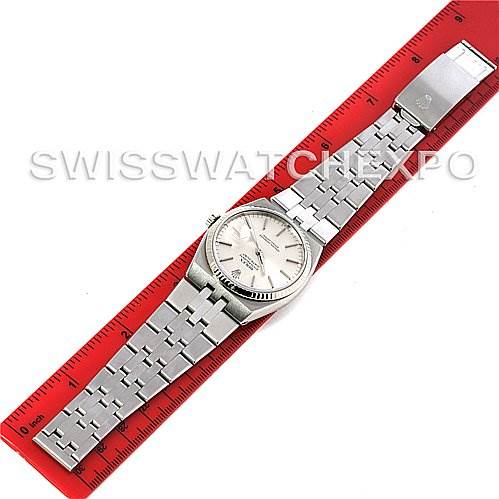 The image shows a Rolex Oysterquartz 17014 Men's Stainless Steel Silver Dial 17014 Men's Stainless Steel Silver Dial watch laid flat against a red ruler, highlighting the watch face and stainless steel bracelet.