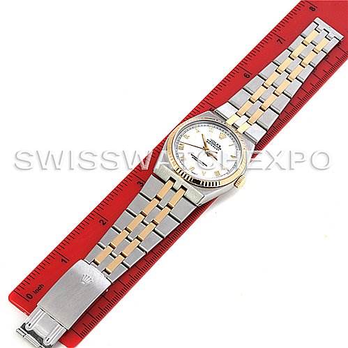 The image shows a top-down view of the Rolex Oysterquartz 17013 Men's Stainless Steel White Dial 17013 Men's Stainless Steel White Dial watch placed next to a red ruler for scale.