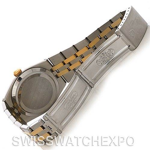 The image shows a partially open Oysterquartz Rolex watch, highlighting the clasp, case back, and bracelet.