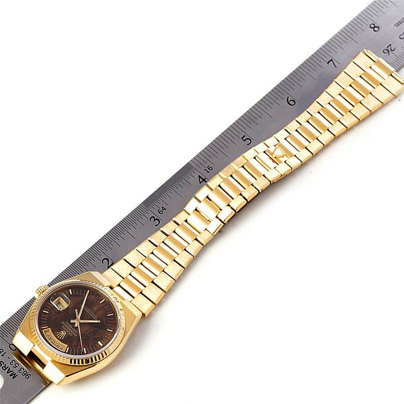 The image shows a gold Rolex Oysterquartz 19018 Men
s Yellow Gold Champagne Dial 19018 Men
s Yellow Gold Champagne Dial watch with a ruler placed next to its band, highlighting the full watch and bracelet.