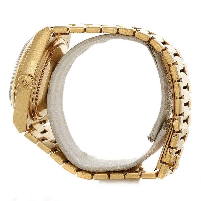 The image shows a side view of the Rolex Oysterquartz 19018 Men
s Yellow Gold Champagne Dial 19018 Men
s Yellow Gold Champagne Dial watch, highlighting its gold case, crown, and metal bracelet.