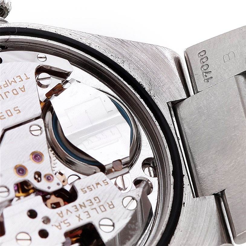 Close-up view of the internal mechanism of a Rolex Oysterquartz 17000 Men's Stainless Steel White Dial 17000 Men's Stainless Steel White Dial watch showing intricate parts and the caseback edge.