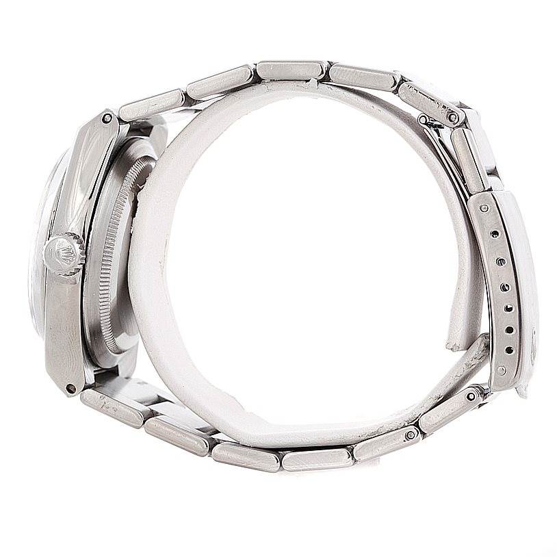 The image shows a side view of a Rolex Oysterquartz 17000 Men's Stainless Steel White Dial 17000 Men's Stainless Steel White Dial watch, highlighting the case, crown, and metal bracelet.