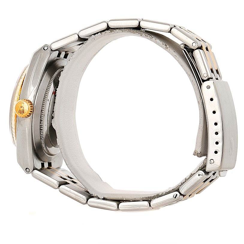 This side view of the Rolex Oysterquartz 17013 Men's Stainless Steel Champagne Dial 17013 Men's Stainless Steel Champagne Dial watch shows its bracelet, crown, and case.