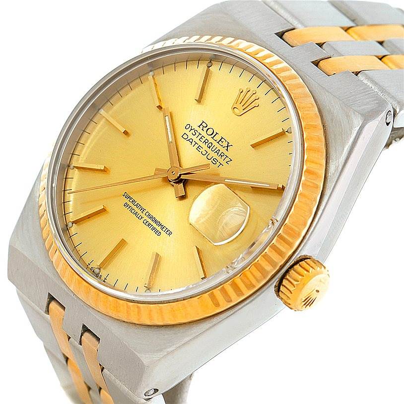 This image shows a close-up, angled view of the Rolex Oysterquartz 17013 Men's Stainless Steel Champagne Dial 17013 Men's Stainless Steel Champagne Dial watch, highlighting the gold dial, fluted bezel, and two-tone bracelet.